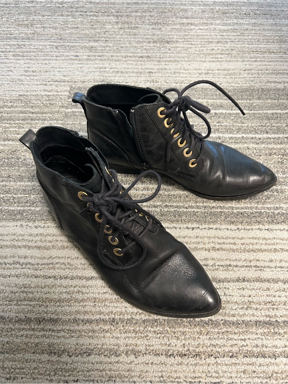 Buttery soft black leather ankle boots with cute silver grommets and pointed toe